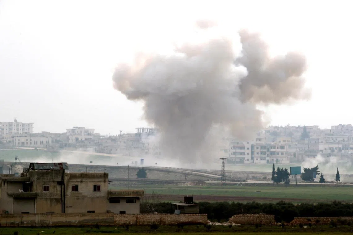 In a 2020 photo, smoke rises after an air strike in Saraqeb in Idlib province, Syria.