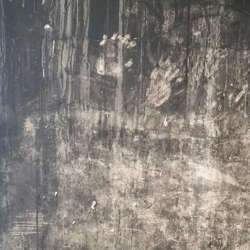 FILE PHOTO: Handprints on a blackened wall at the Grenfell Tower block of flats, the site of a June 2017 deadly fire, s family members of victims have said they will take legal action against the government unless it reverses a decision not to preserve a section of the tower's wall, bearing handprints they believe belong to victims or survivors, for a future memorial, in London, Britain, July 2025. Work to dismantle the tower started in September 2025. Karim Khalloufi/Handout via REUTERS/File Photo