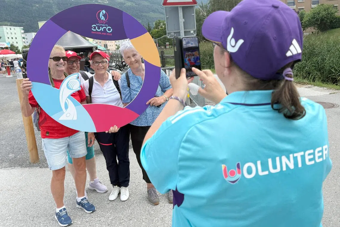 Former Swiss national team players Cathy Moser, Nelly Juillard, Rosemarie Siggen and Elisabeth Copt pose with a UEFA women’s soccer Euro sign at Tourbillon stadium in Sion, Switzerland, July 3, 2025.  REUTERS/Cecile Mantovani