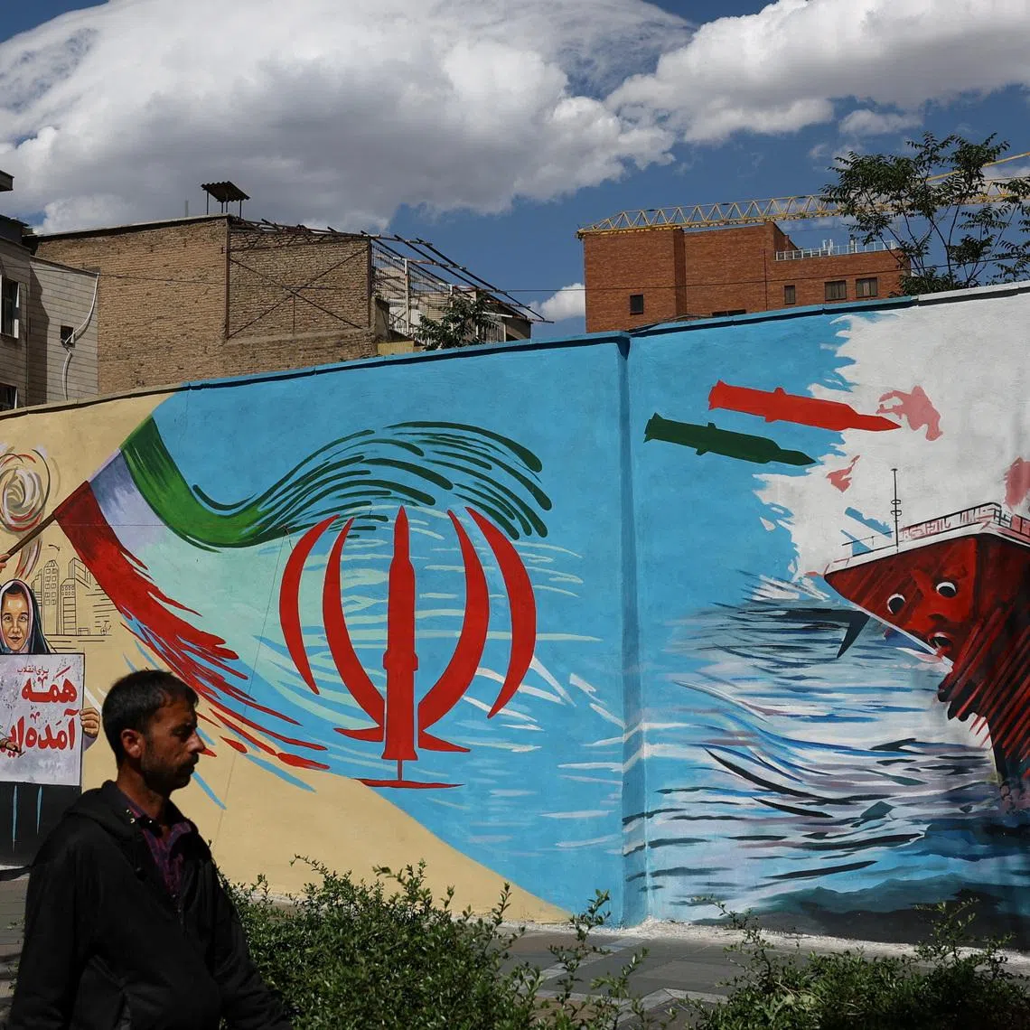 People walk on a street near a mural featuring an image of the late Supreme Leader of Iran, Ayatollah Ali Khamenei, in Tehran, Iran, May 18, 2026. Majid Asgaripour/WANA (West Asia News Agency) via REUTERS