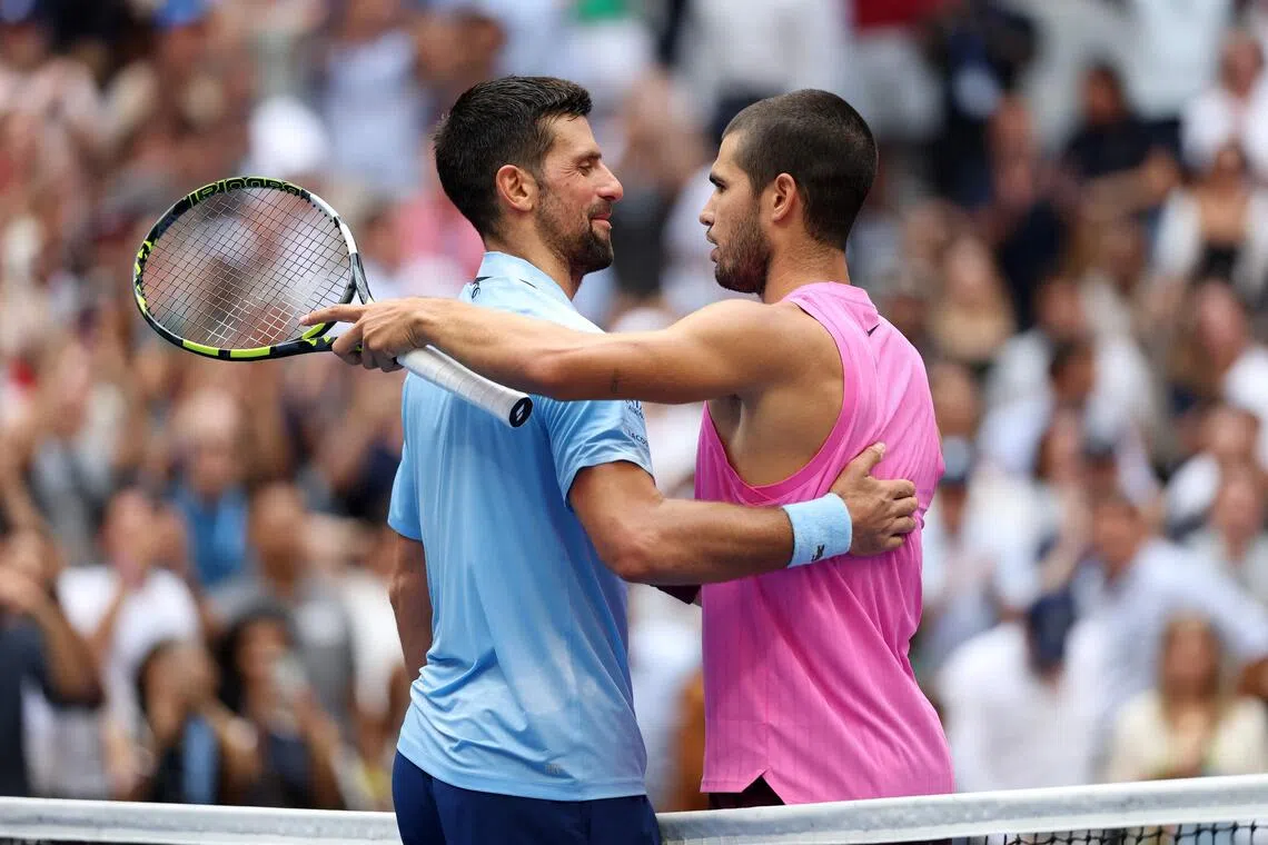 Carlos Alcaraz (right) embracing Novak Djokovic after defeating the Serb in the US Open semi-finals in September.