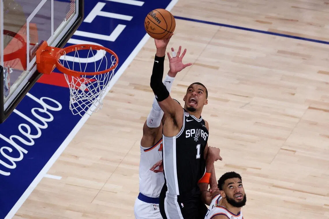 San Antonio Spurs forward Victor Wembanyama shoots the ball against New York Knicks center Karl-Anthony Towns during Game 3.   