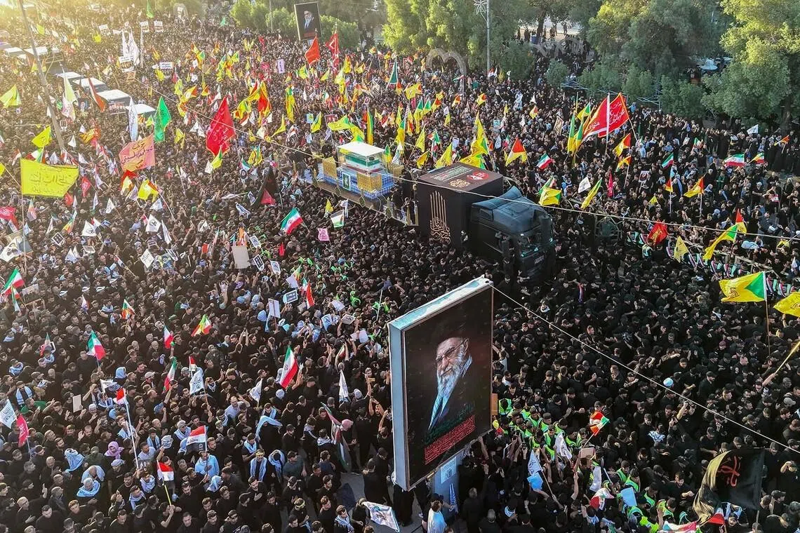 TOPSHOT - Crowds of mourners surround the convoy carrying the coffin of Iran's slain supreme leader Ali Khamenei during a funeral procession in Najaf on July 8, 2026. Funeral processions carrying the coffin of Iran's slain supreme leader Ali Khamenei will pass on July 8 through Iraq's holy cities of Najaf and Karbala, home to Shia Islam's most sacred shrines. (Photo by Zaid AL-OBEIDI / AFP)
