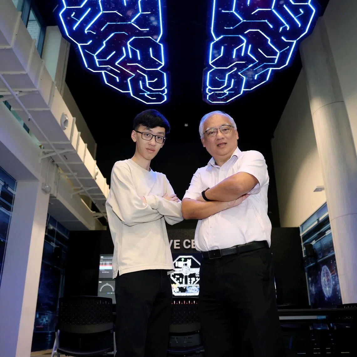 Profile of Mr Tay Tse Wan (right), 60, branch manager (South Asia Pacific Region), and his son Tay Quan Kai, 23, a Temasek Polytechnic alumnus, at Temasek Polytechnic's Advanced Manufacturing Centre on April 7, 2026. They are both pursuing a Specialist Diploma in AI Solutions Development at TP.