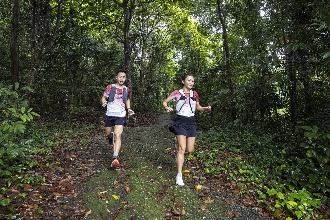 ST20250907_202514000821/kkrun07/Brian Teo/Kimberly Kwek MR/(From Left) Singaporean trail and ultra runners Chew Jing Yan and Lim Wen Yi training for their upcoming World Mountain and Trail Running Championships at the trails in Dairy Farm Nature Park on Sept 7, 2025. ST PHOTO: BRIAN TEO 