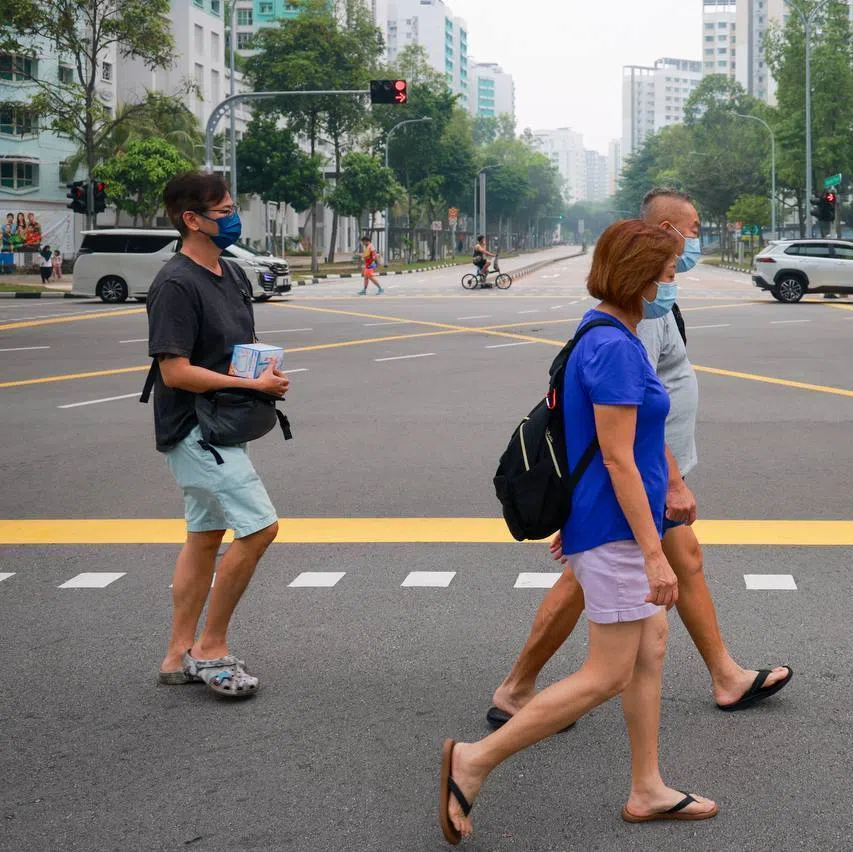 Pedestrians wearing masks amid hazy conditions in Punggol on Oct 12.