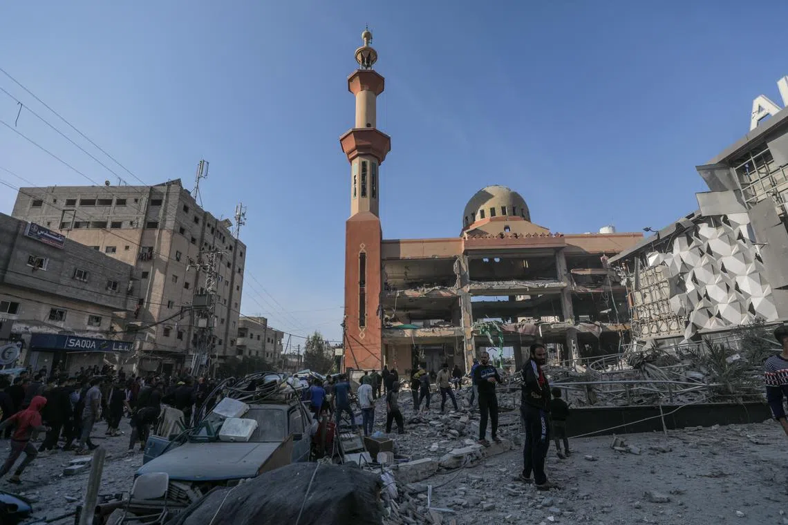 Palestinians check the destroyed Al Farouq Mosque following an Israeli airstrike in central Gaza Strip, on Nov 23.