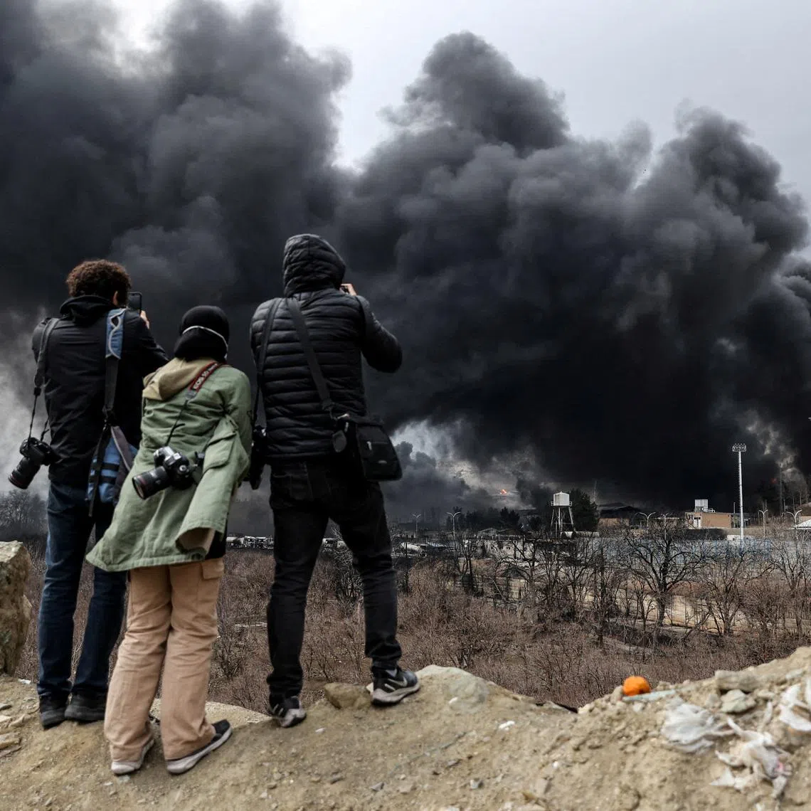 People record smoke rising after a reported strike on Shahran fuel tanks, amid the U.S.-Israeli conflict with Iran, in Tehran, Iran, March 8, 2026. Majid Asgaripour/WANA (West Asia News Agency) via REUTERS
