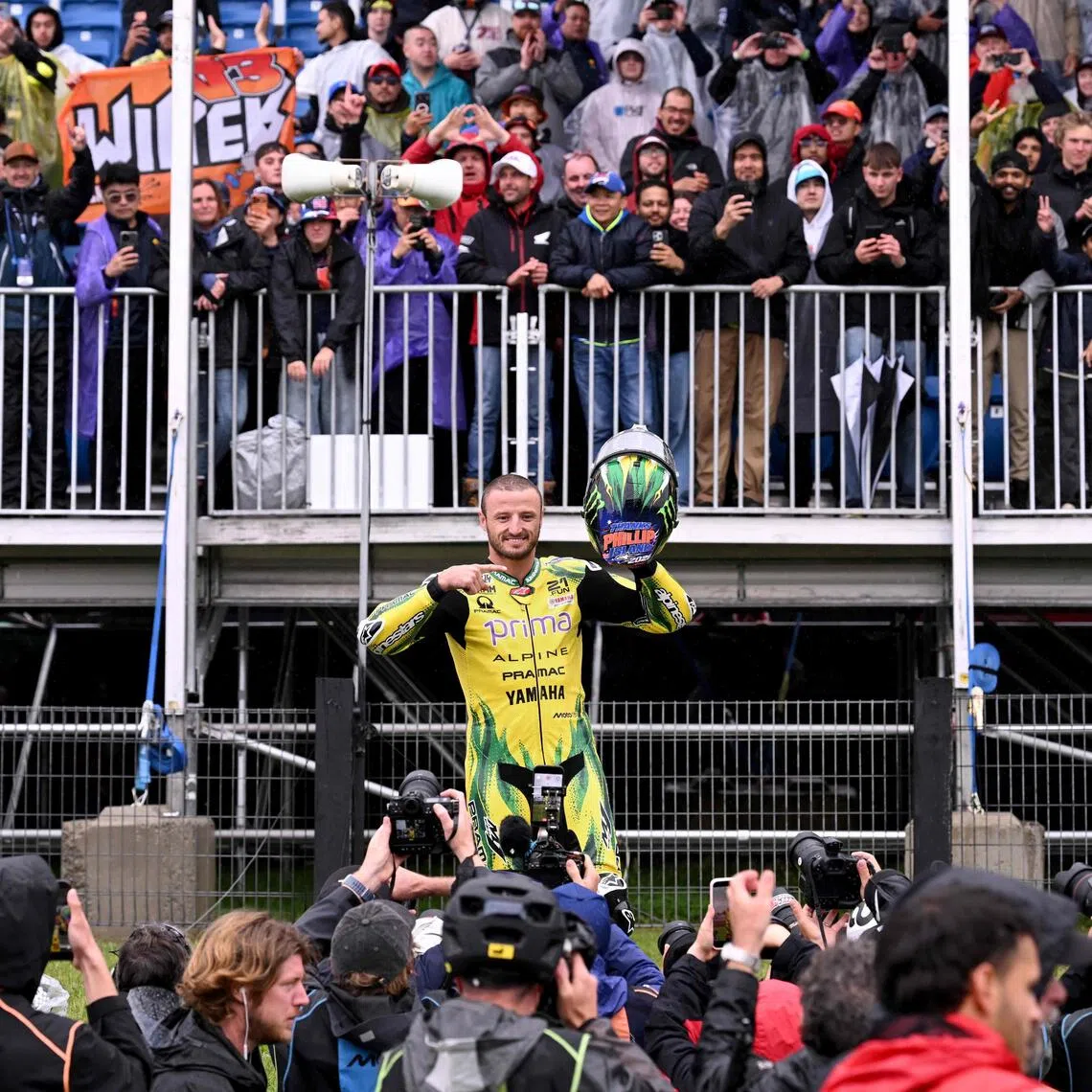 Australian rider Jack Miller gestures to the crowds after a farewell lap following the cancellation of the last Australian MotoGP Grand Prix to be held at Phillip Island on Oct 25 due to inclement weather conditions.