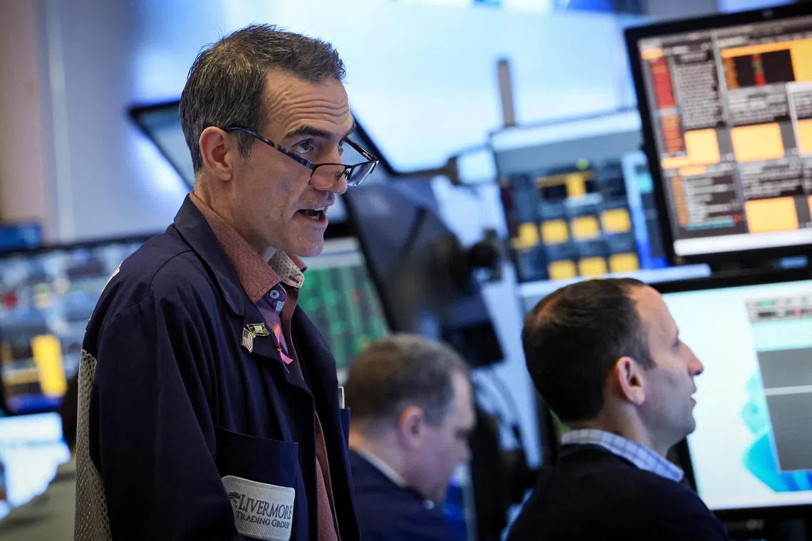 Traders work on the floor at the New York Stock Exchange, in New York City.