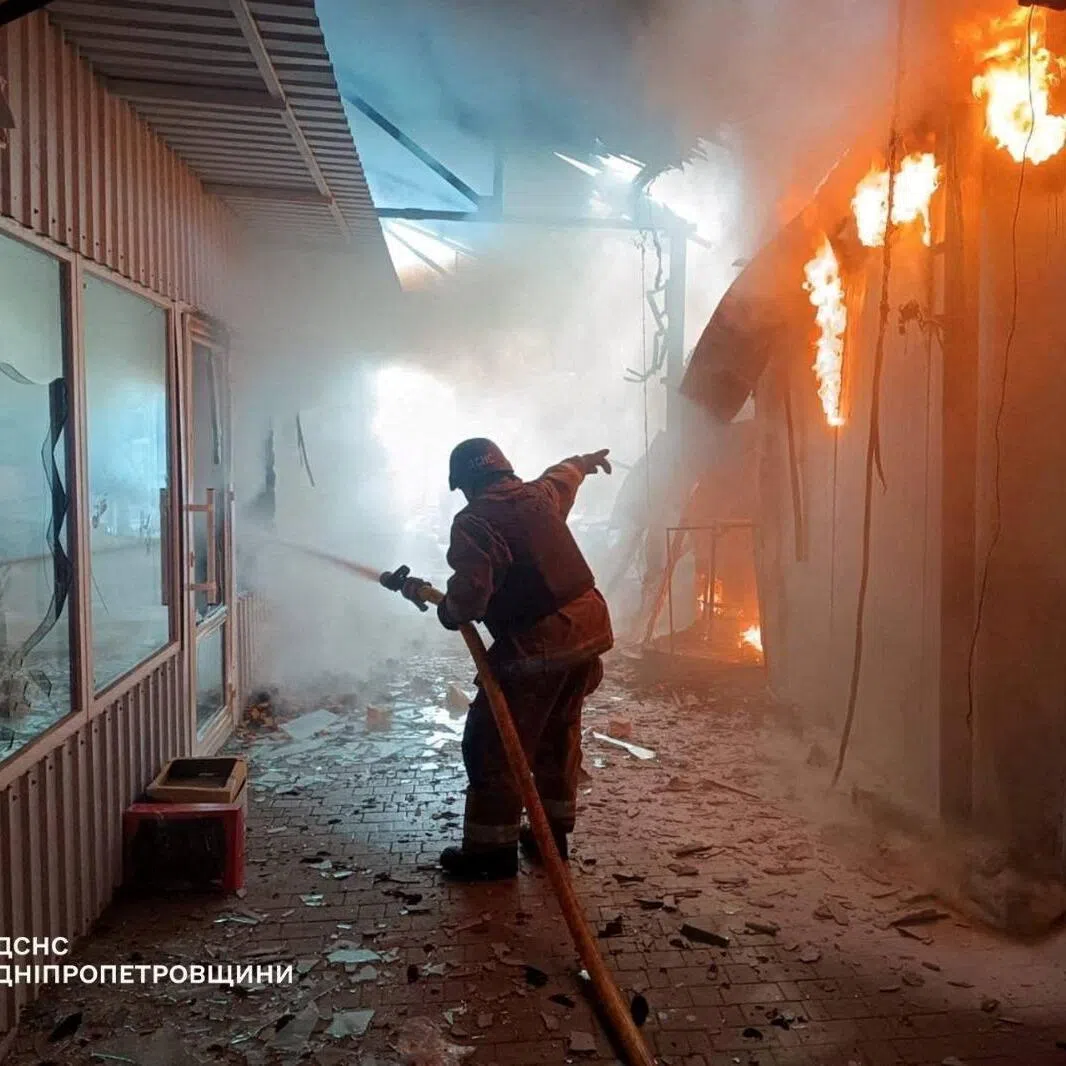 A firefighter working at a street market hit by a Russian drone strike, in Nikopol, Ukraine,  onApril 4.