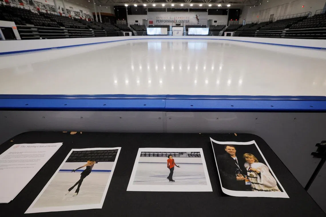 Photographs of athletes Jinna Han and Spencer Lane, and coaches Vadim Naumov and Yevgenia Shishkova are displayed at the Skating Club of Boston in Norwood, Massachusetts.