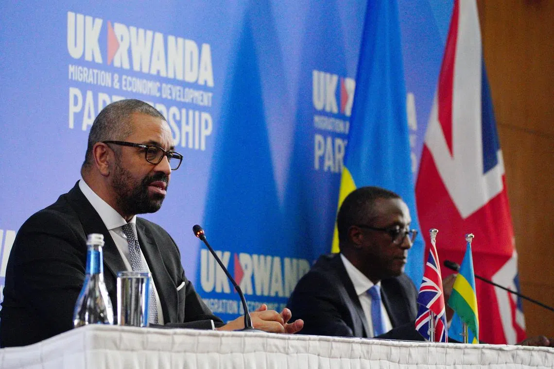 Britain's Home Secretary James Cleverly (left) and Rwandan Foreign Minister Vincent Biruta attend a joint press conference after signing the new treaty in Kigali.