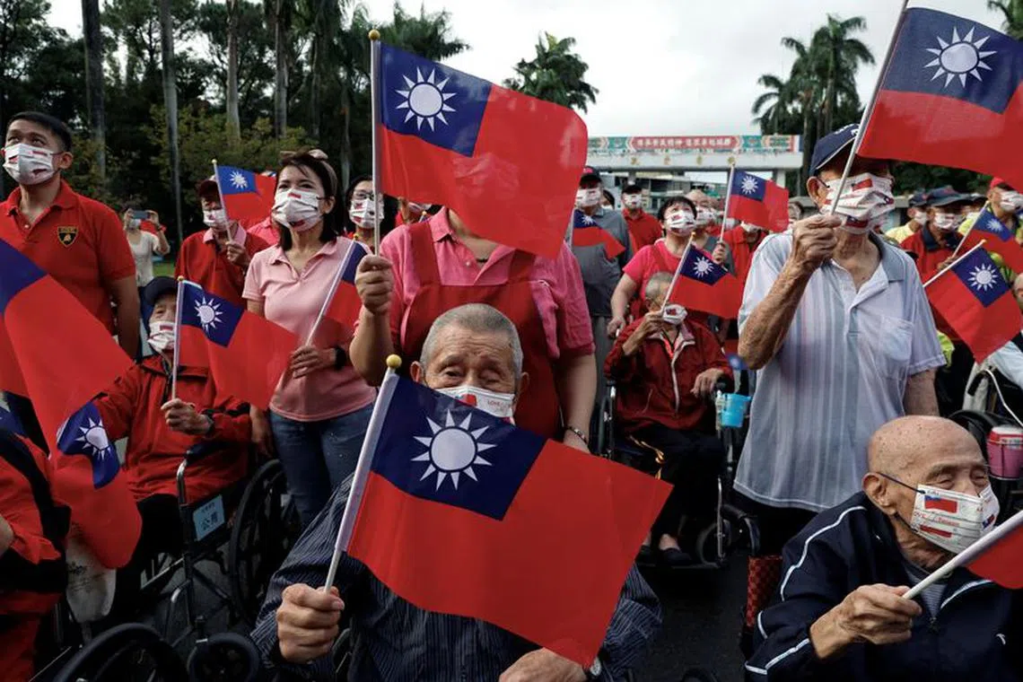 Residents and caretakers at Taoyuan Veterans Home wave Taiwanese flags while celebrating National Day in Taoyuan, Taiwan October 10, 2023.  REUTERS/Ann Wang