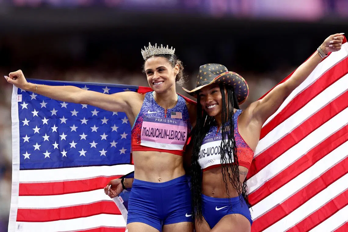 Women 400m hurdles winner Sydney McLaughlin-Levrone (left) celebrating with long Jump winner Tara Davis-Woodhall  celebrate at the end of their Olympic finals.