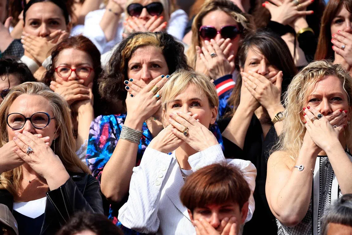 French actress Judith Godreche (centre) gesturing as she poses with women belonging to associations working to prevent violence against women, on the stairs of the Palais des Festivals, on the sidelines of the 77th edition of the Cannes Film Festival in Cannes, southern France, on May 16, 2024.