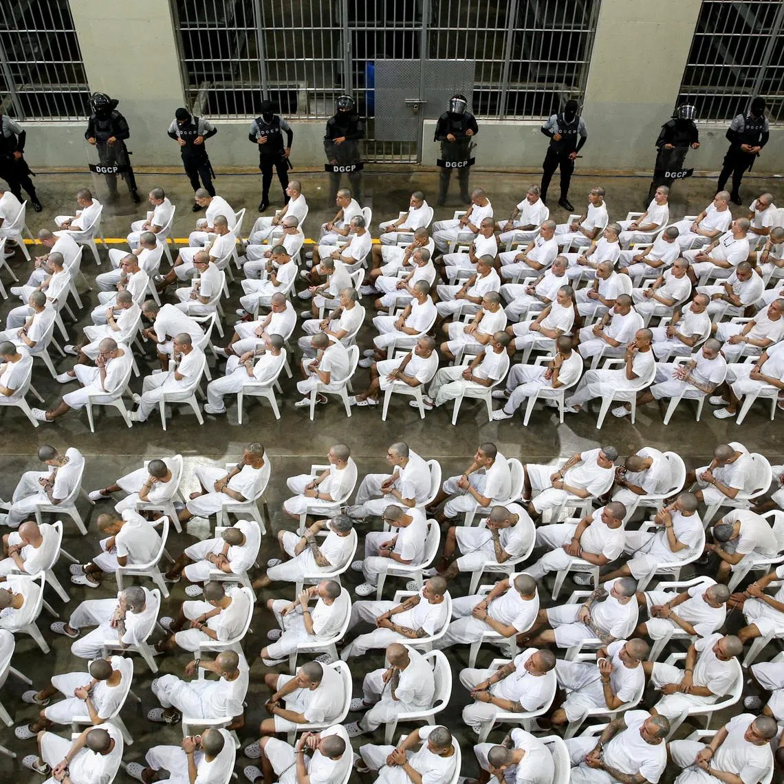 Alleged members of MS-13, attend an open hearing in a mass trial, after 486 alleged gang members were charged with more than 47,000 crimes committed between 2012 and 2022, according to prosecutors, at the Terrorism Confinement Center (CECOT) in Tecoluca, El Salvador, April 23.  REUTERS/Jose Cabezas