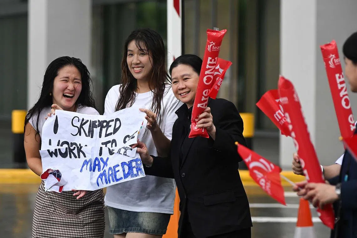 ST20240814-202400800912-Lim Yaohui-Osmond Chia-dgbus14/ Supporters with a poster which says 'I skipped work to see Max Maeder' near the bus stop at Bayfront Avenue (in front of Sands Expo & Convention Centre) for the open-top bus parade to celebrate Team Singapore's Olympians, including bronze medallist Max Maeder, on Aug 14, 2024. To honour the fighting spirit and tenacity that our Olympians displayed at the Games, Sport Singapore will be organising a One Team Singapore celebratory parade in the city area. The parade will wind through the heart of the city, offering members of the public a chance to cheer on our Team Singapore Olympians at five cheer points, as they travel on an open-top bus. (ST PHOTO: LIM YAOHUI)