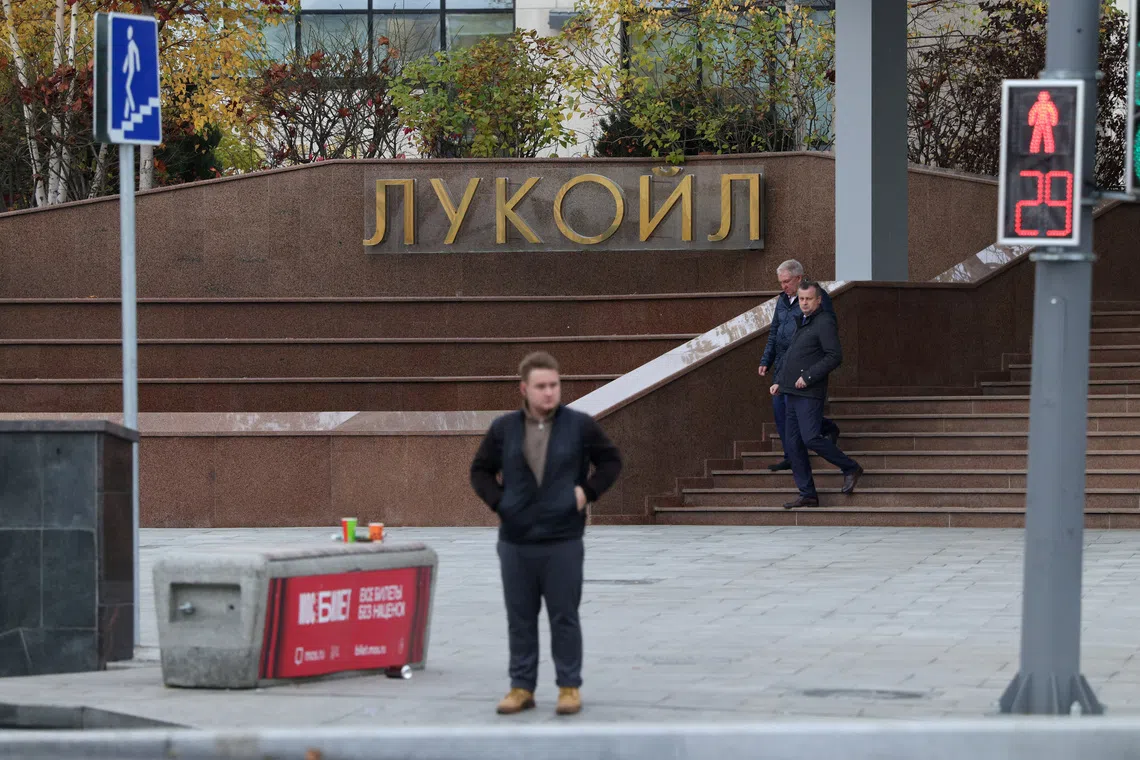 Men walk downstairs outside the headquarters of Lukoil, one of Russia's major oil companies, in Moscow, Russia, October 23, 2025. REUTERS/Ramil Sitdikov