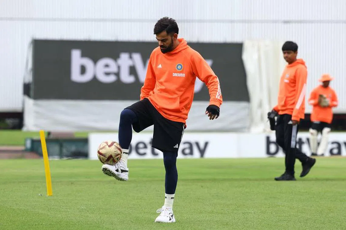 Cricket - First Test - South Africa v India - SuperSport Park Cricket Stadium, Centurion, South Africa - December 26, 2023 India's Virat Kohli plays with a football as he warms up before the start of play REUTERS/Esa Alexander
