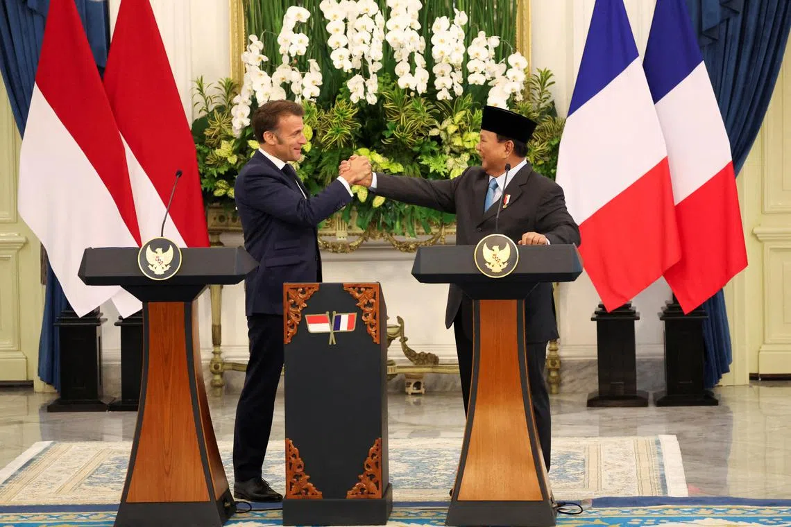 French President Emmanuel Macron shakes hands with Indonesian President Prabowo Subianto after a press conference in Jakarta on May 28.   