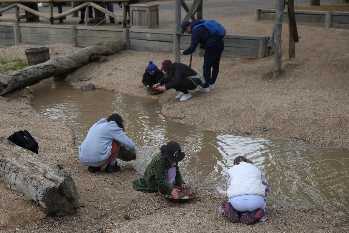 Children pan for gold at Sovereign Hill living museum in Ballarat, Australia.
