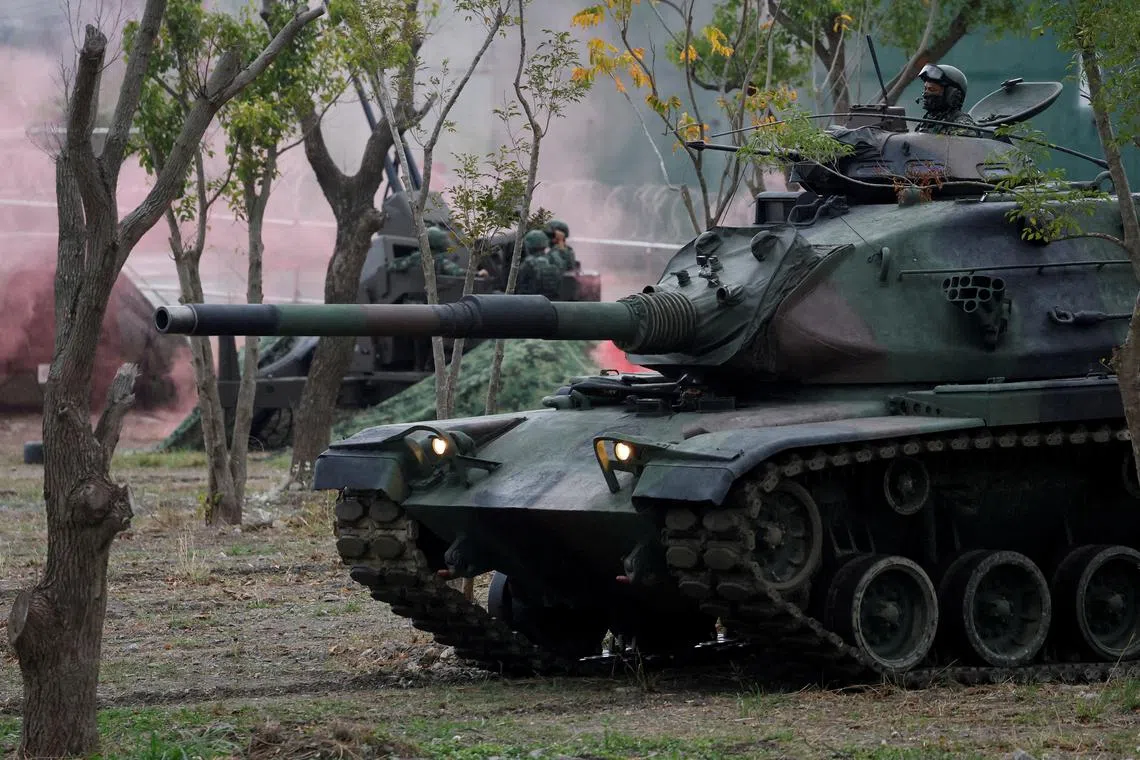 FILE PHOTO: Members of Taiwan's armed forces, riding on a M60A3 tank, participate in a drill as part of a demonstration for the media to show combat readiness, ahead of the Lunar New Year holidays, at a military base in Taitung, Taiwan January 31, 2024. REUTERS/Carlos Garcia Rawlins/File Photo