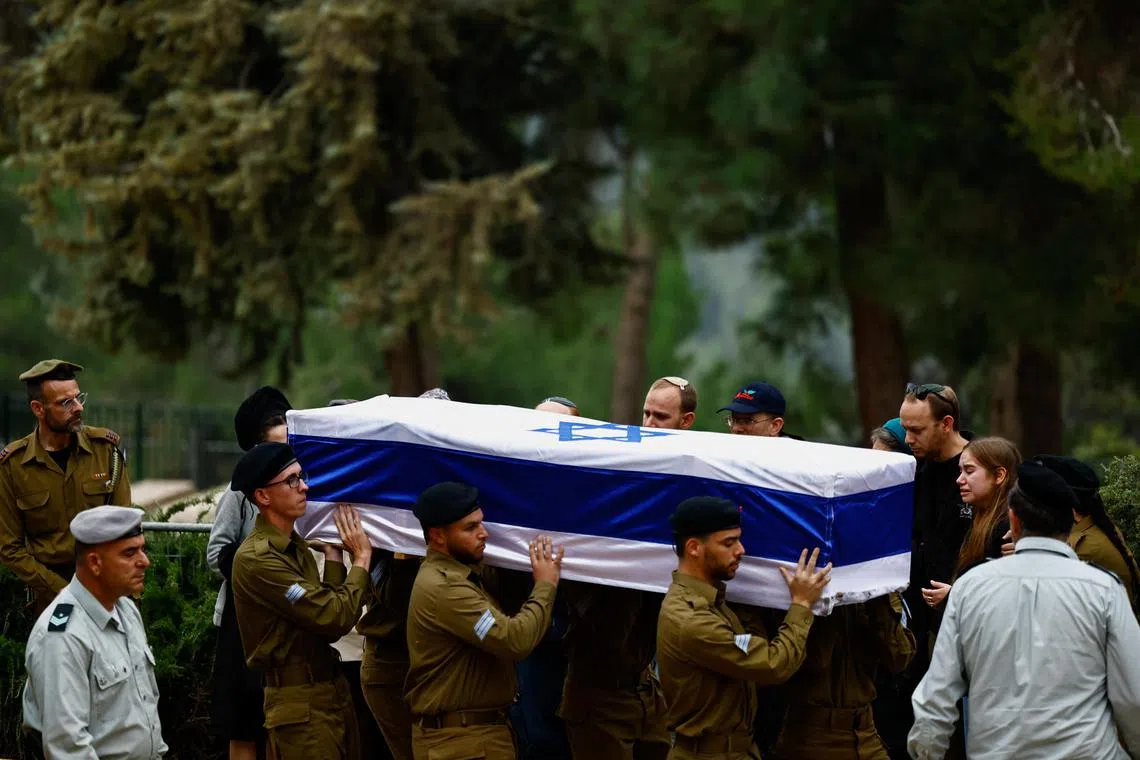 Israeli soldiers carry the casket of  Sergeant Yakir Yedidya Schenkolewski, 21, who was killed in Gaza during Israel's ongoing ground operation against Hamas.