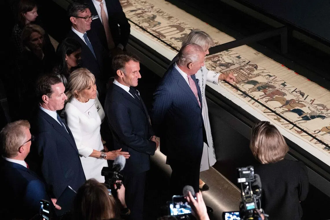 Britain’s King Charles (second from right) and Queen Camilla (right) with French President Emmanuel Macron (centre) and his wife Brigitte Macron (third from left) view sections of the Bayeux Tapestry at the British Museum.