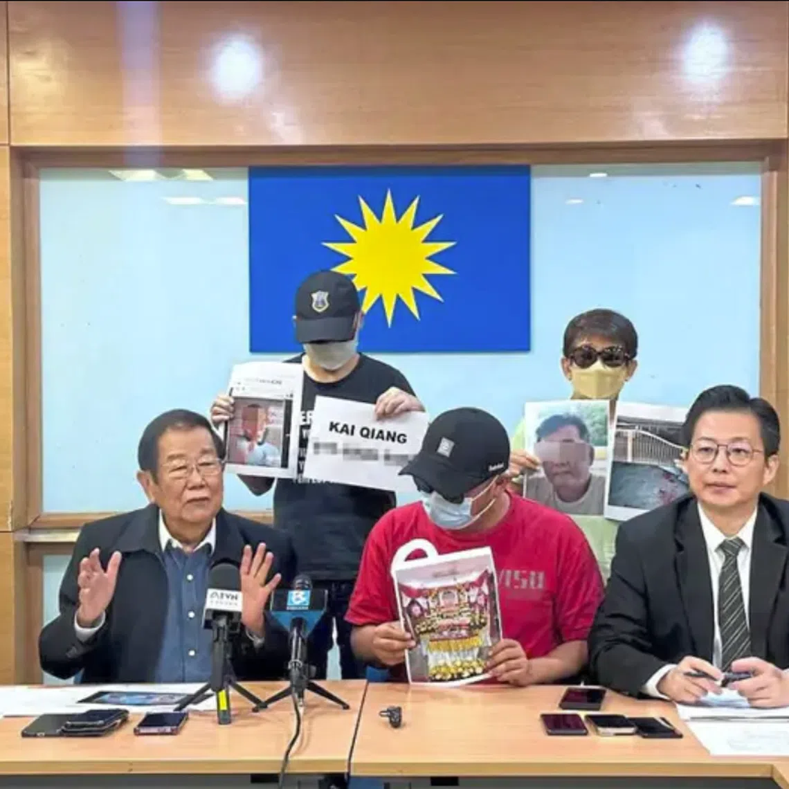 Mr Chong (seated, left) and Mr Ivan (right) holding a conference alongside the three ah long victims in Kuala Lumpur.