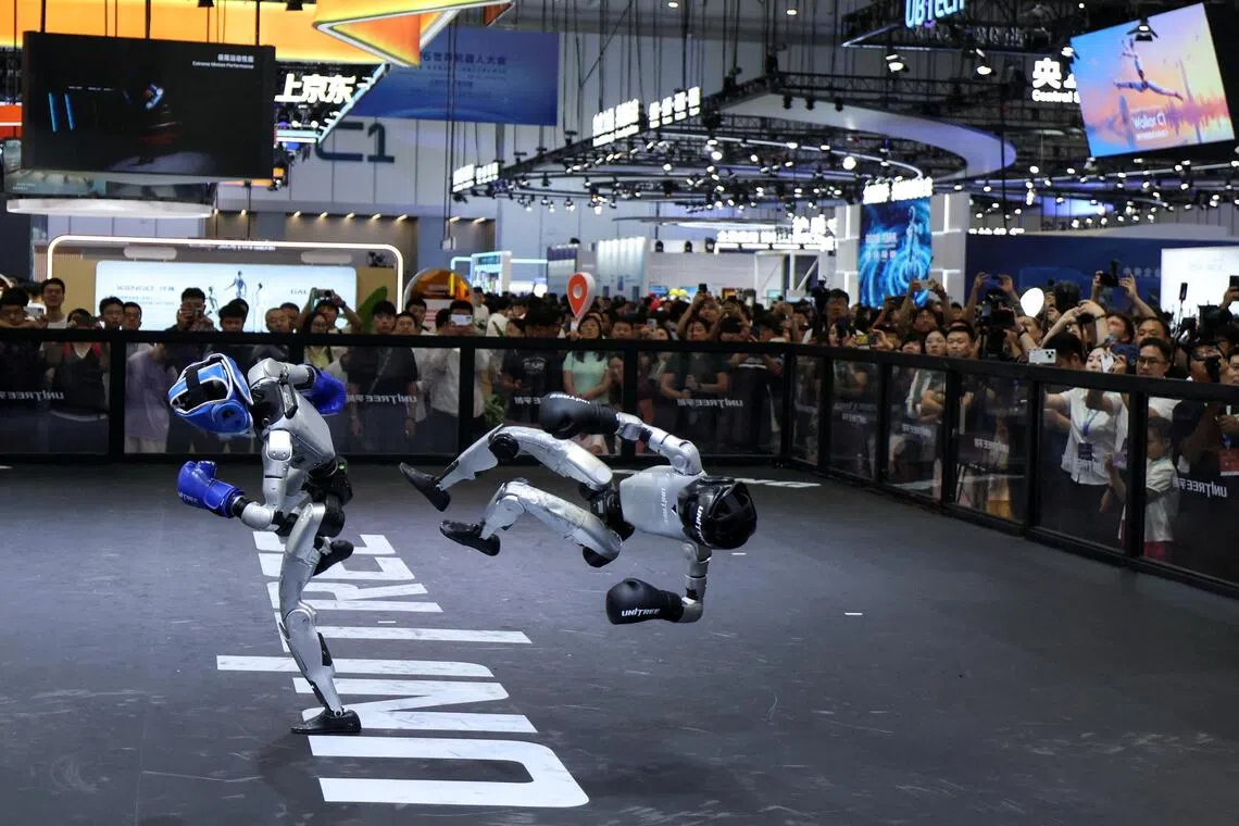 Two humanoid robots by Unitree Robotics demonstrate kickboxing during the World Robot Conference in Beijing on Aug 19.