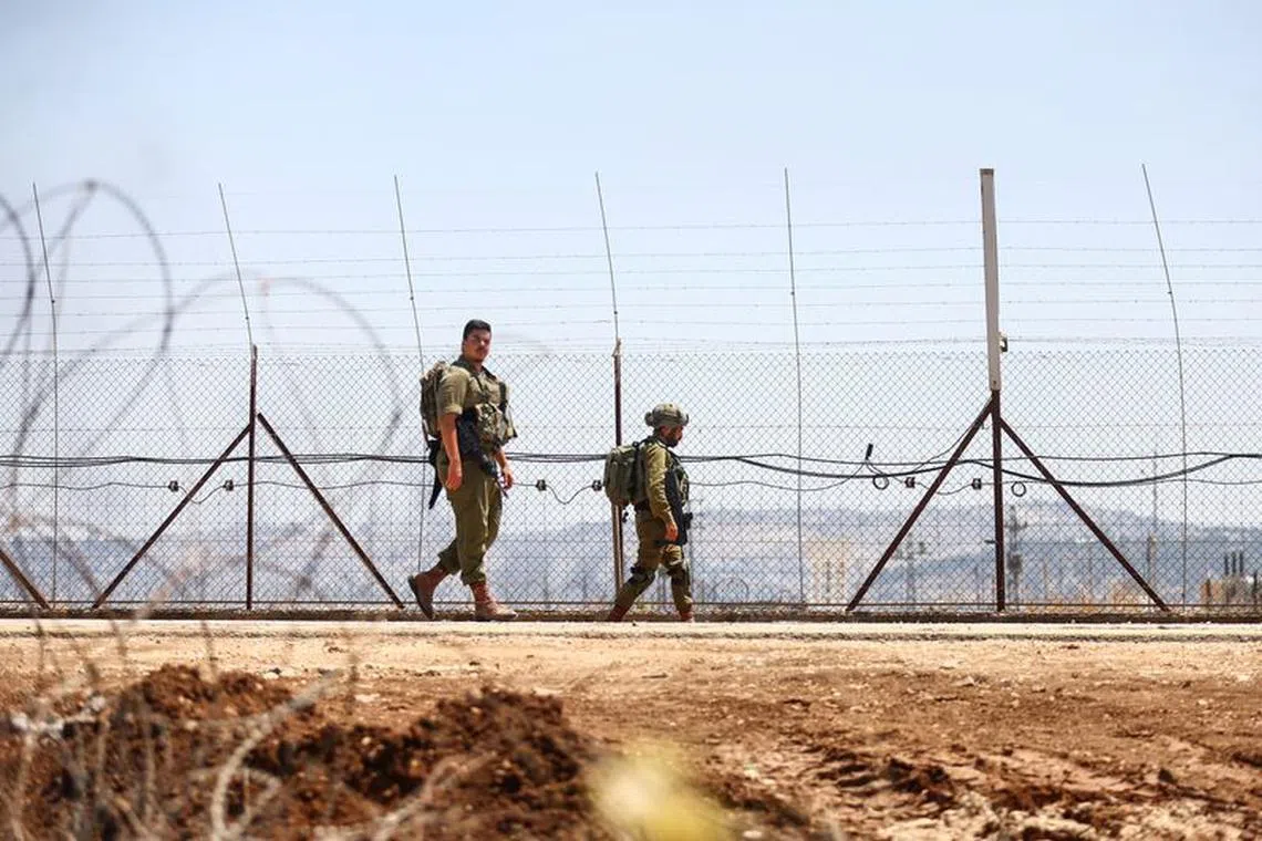 Israeli military patrol a border during a raid on Jenin refugee camp at Salem checkpoint, the entrance from Israel to Jenin in the Israeli-occupied West Bank, July 3, 2023 REUTERS/Ronen Zvulun/File photo