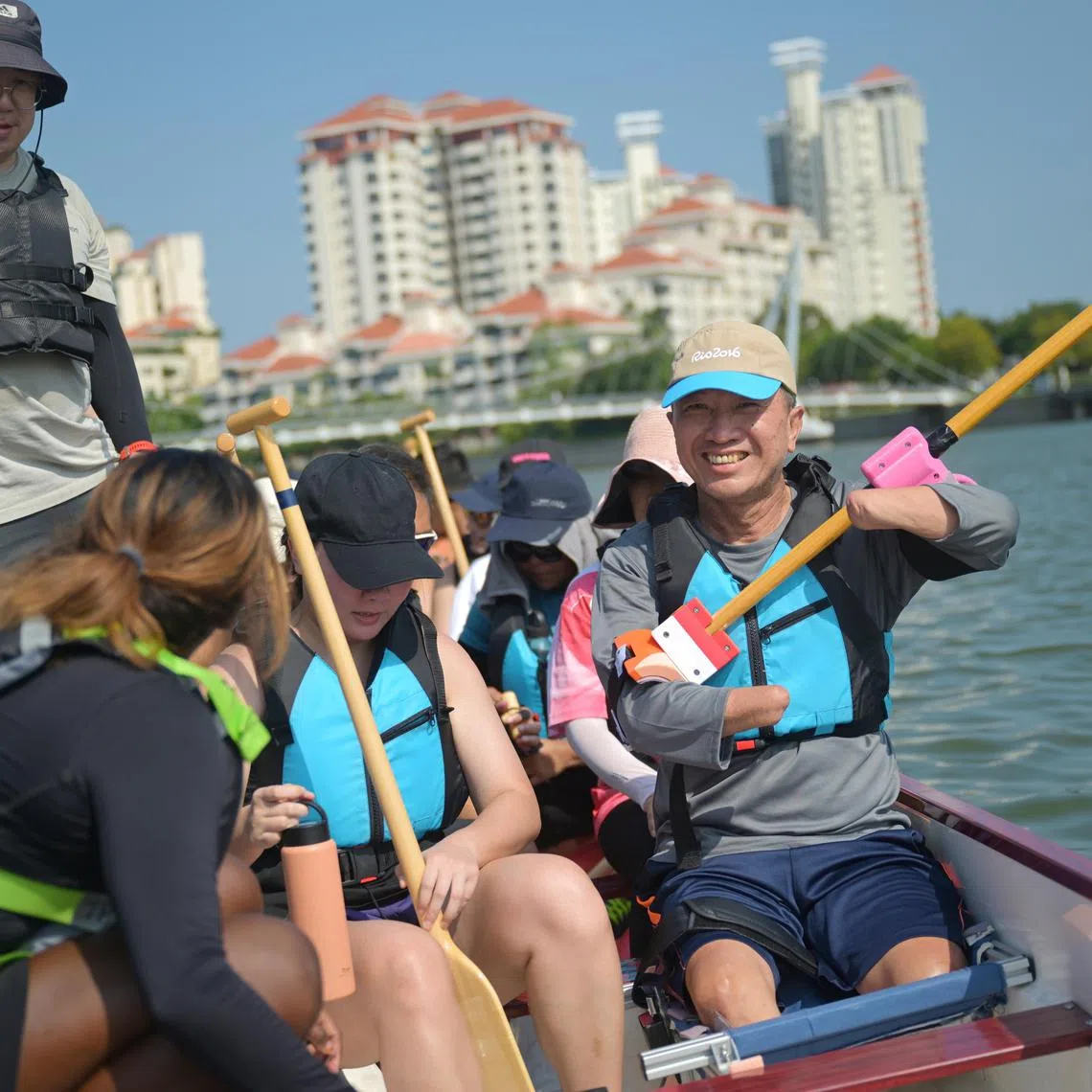 Mr Tan Whee Boon (right), 59, a quad amputee, in a dragon boat at Water Sports Centre to train for Pesta Sukan on July 20.  ST PHOTO: AZMI ATHNI