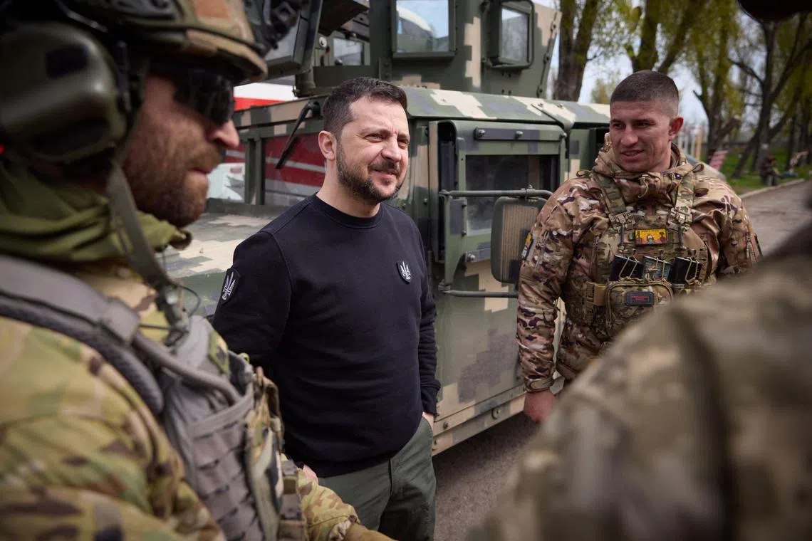Ukrainian president Volodymyr Zelensky (centre) visits servicemen in the front-line town of Avdiivka, in Ukraine's Donetsk region.