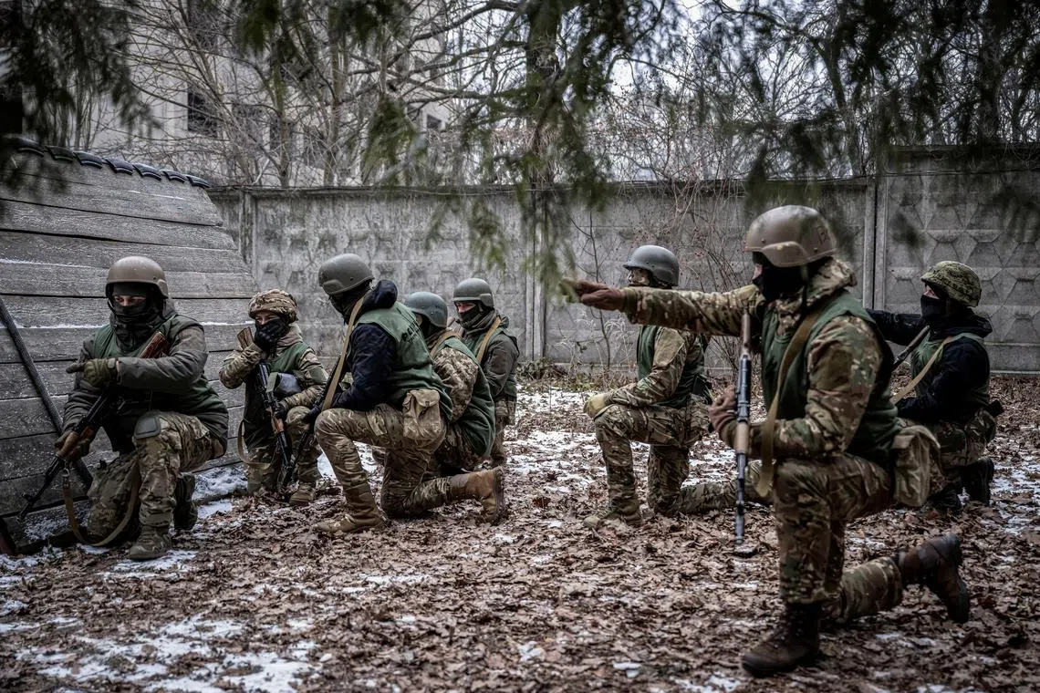 FILE PHOTO: Volunteers who aspire to join the 3rd Separate Assault Brigade of the Ukrainian Armed Forces listen to an instructor during basic training, amid Russia's attack on Ukraine, at an undisclosed location in the Kyiv region, Ukraine January 9, 2024. REUTERS/Viacheslav Ratynskyi/File Photo