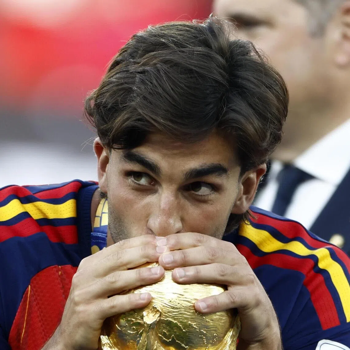 Ferran Torres of Spain kisses the World Cup trophy after the final against Argentina.