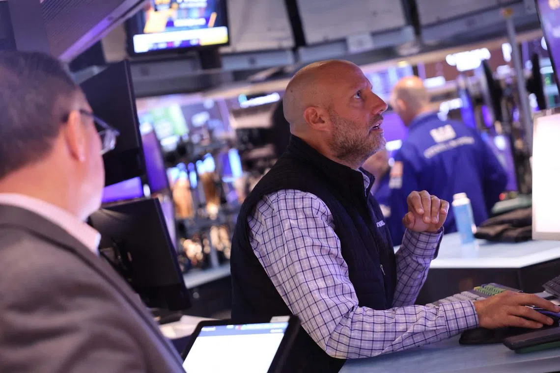 Traders work on the floor of the New York Stock Exchange, in New York City. 