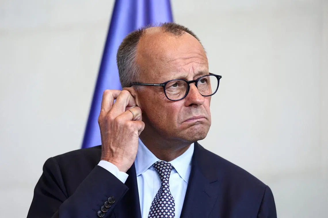 German Chancellor Friedrich Merz attends a press conference with Ukrainian President Volodymyr Zelenskiy (not pictured), on the day they attend a virtual meeting with U.S. President Donald Trump and European leaders on the upcoming Trump-Putin summit on Ukraine, in Berlin, Germany, August 13, 2025. REUTERS/Liesa Johannssen/File Photo