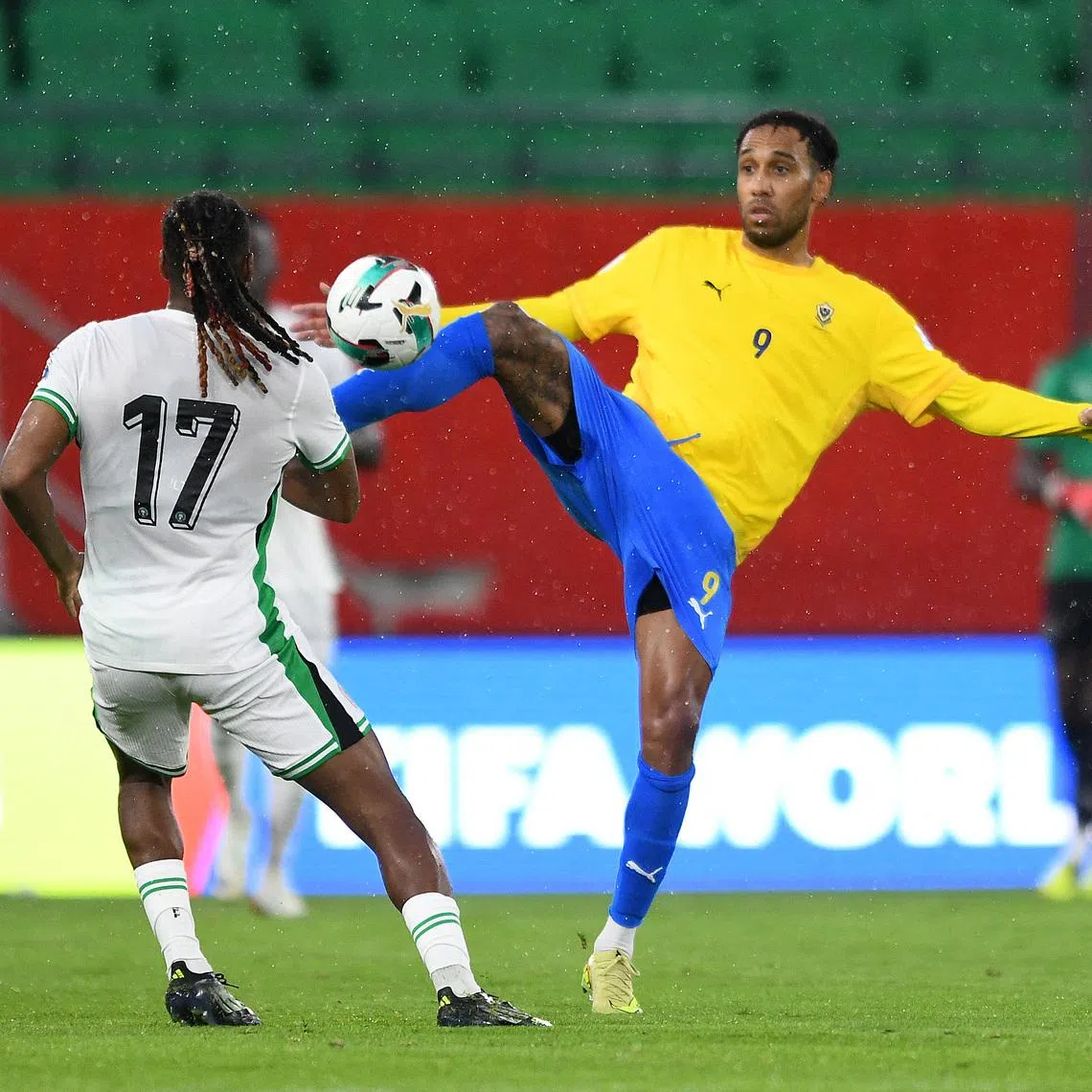 Soccer Football - FIFA World Cup - CAF Qualifiers - Playoffs - Semi Final - Nigeria v Gabon - Prince Moulay Hassan Stadium, Rabat, Morocco - November 13, 2025 Nigeria's Alex Iwobi in action with Gabon's Pierre-Emerick Aubameyang REUTERS/Stringer