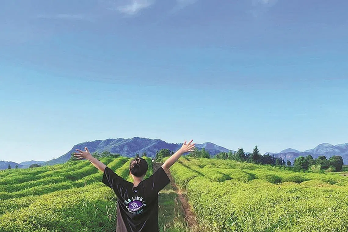 Ms Tang Xue, 24, enjoying the open air on the farm she bought in Anji county, Zhejiang province, after resigning from jobs at three short-video companies. 