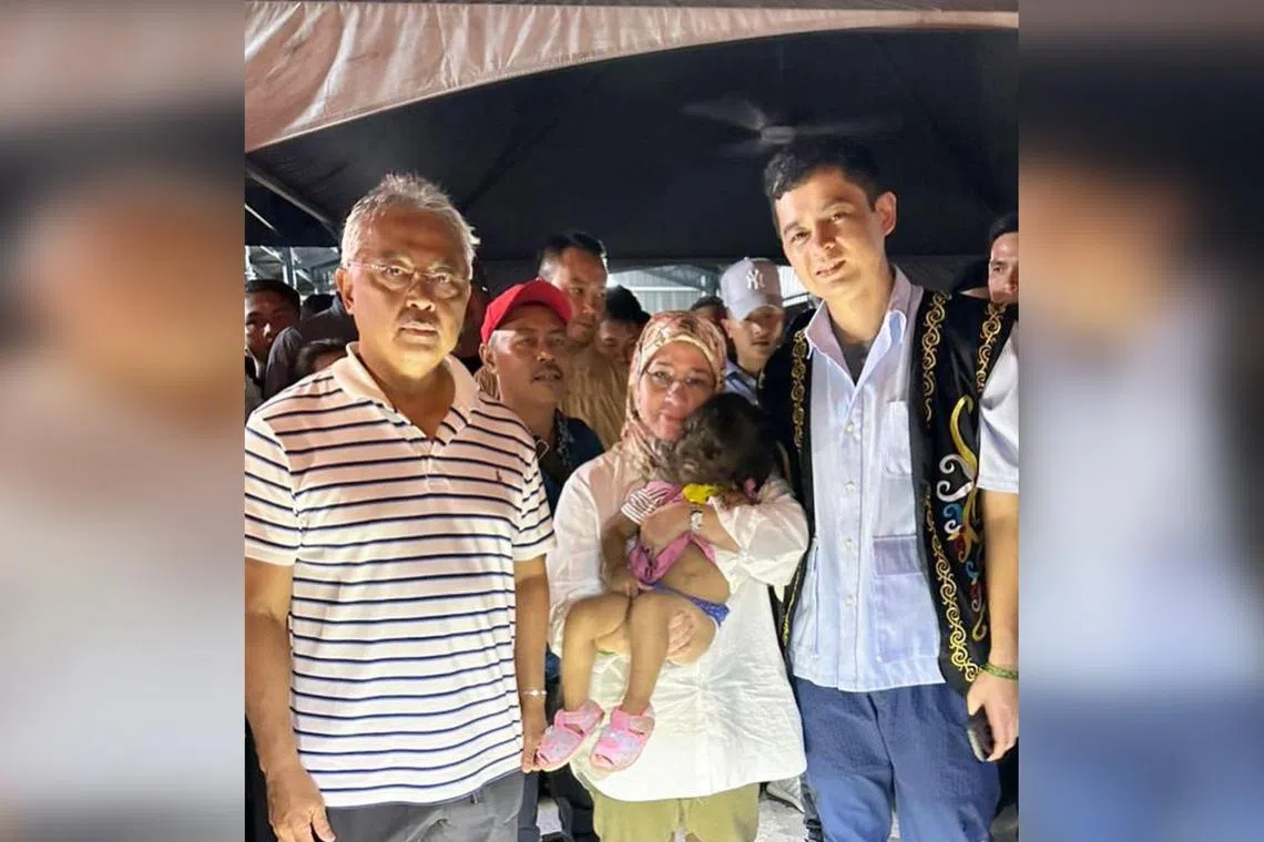 (From left) Sultan Abdullah Ahmad Shah, his consort, Tunku Azizah Aminah Maimunah Iskandariah, and Pahang Regent Tengku Hassanal Ibrahim Alam Shah with toddler Missclyen Roland (centre).