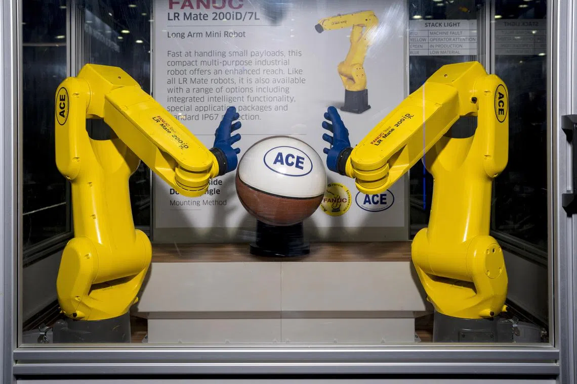 Ñ PHOTO MOVED IN ADVANCE AND NOT FOR USE - ONLINE OR IN PRINT - BEFORE 3:01 A.M. ET ON SUNDAY, JULY 30, 2023 Ñ  A Fanuc robot demonstrates its reach and dexterity by handling a basketball at the Automate Show in Detroit on May 24, 2023. The industry consultant Ron Kyslinger believes that robots can free humans from boredom, physical strain and productivity limits, but that working alongside robots is not without some risk.  (Nic Antaya/The New York Times)