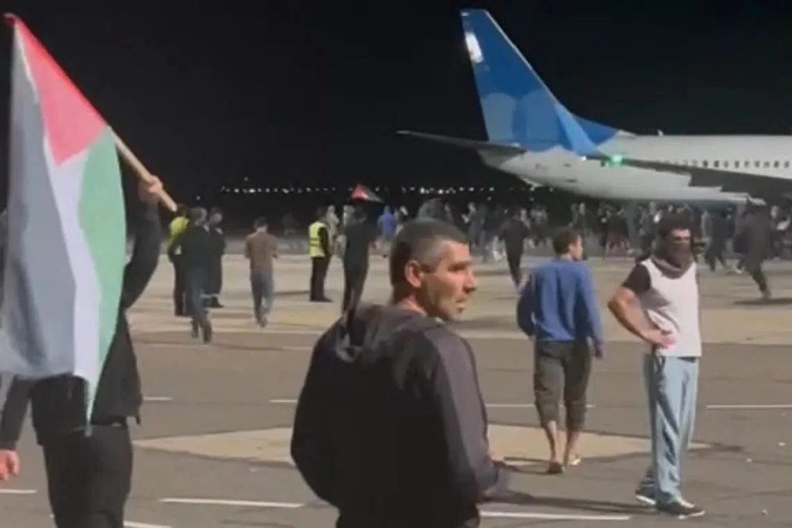 This frame grab taken from a video footage shows protesters on the apron of the Makhachkala airport on Oct 29, 2023.