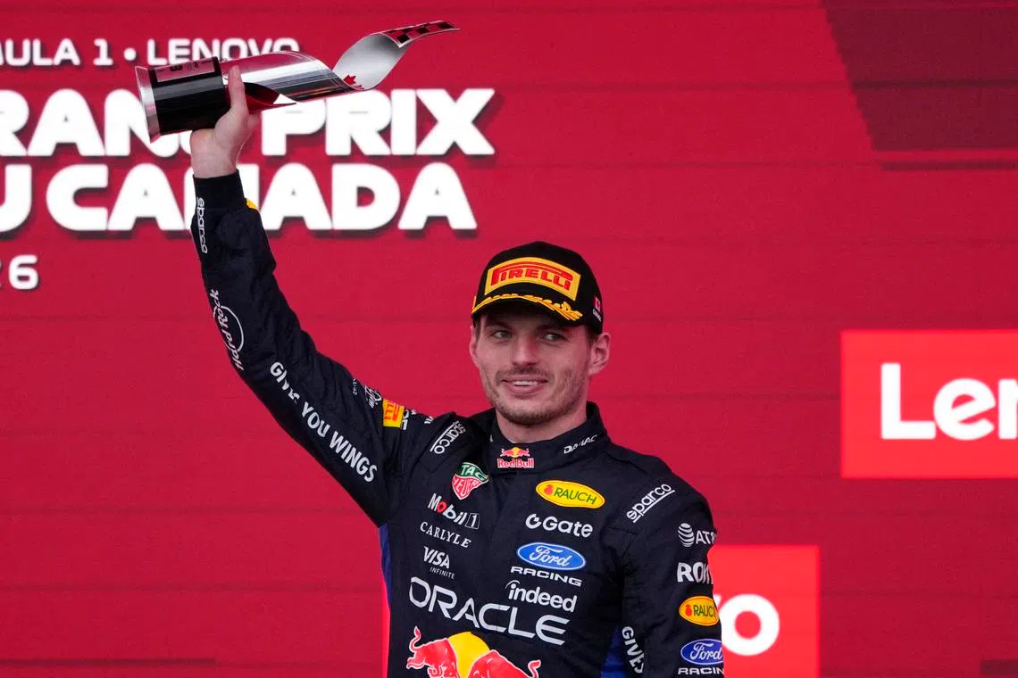 Formula One F1 - Canadian Grand Prix -  Circuit Gilles Villeneuve, Montreal, Quebec, Canada - May 24, 2026 Red Bull's Max Verstappen celebrates on the podium with a trophy after finishing third place in the Canadian Grand Prix REUTERS/Mathieu Belanger
