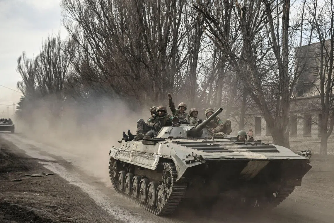 Ukrainian servicemen head towards Bakhmut in a BMP infantry fighting vehicle, in eastern Ukraine, on March 22, 2023.