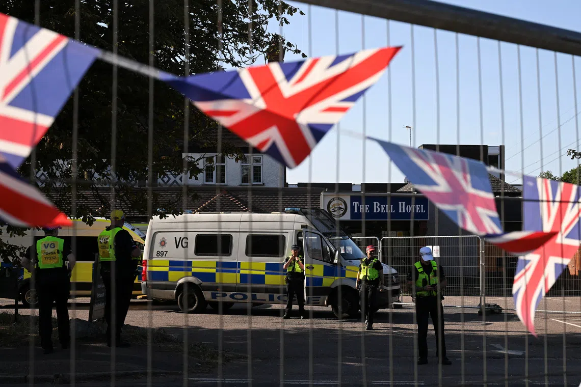 Police officers guard the entrance of the Bell Hotel, as demonstrators attend an anti-immigration protest, in Epping, Britain, August 8, 2025. REUTERS/Jaimi Joy/File Photo
