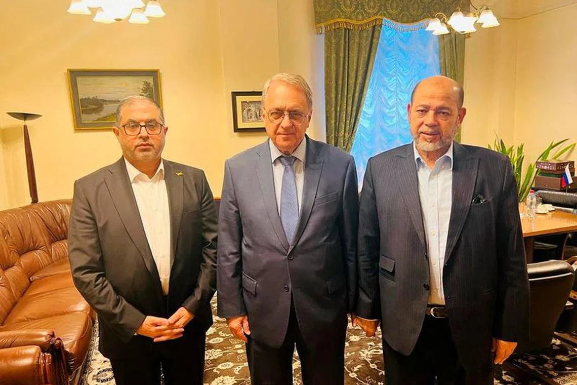Senior Hamas officials Bassem Naim and Moussa Abu Marzouk, and Russia's Deputy Foreign Minister Mikhail Bogdanov meet for talks on the release of foreign hostages, at a location given as Moscow, Russia in this handout image released on October 26, 2023.   Hamas Handout/Handout via REUTERS