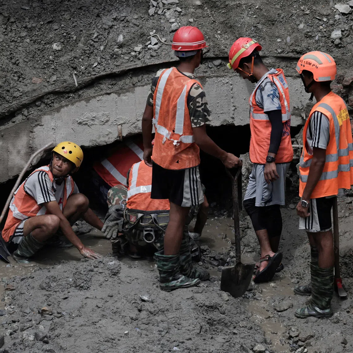 Rescue team members work to enter the tunnel at the Upper Trishuli 3A Hydropower Station as they search for survivors and retrieve bodies.