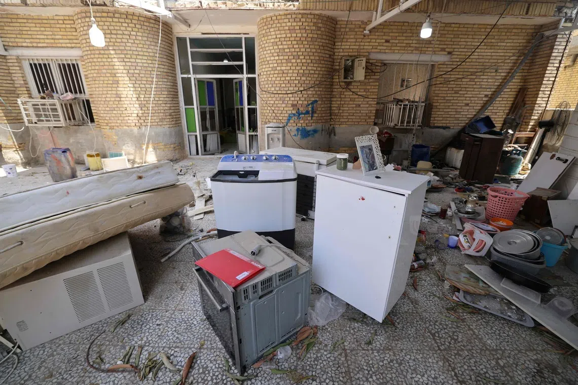 Household items are taken out of a damaged building and placed in the yard following a US strike earlier in the week on Kuhestak, Sirik County, in Iran's southern Hormozgan province on September 6, 2026. A deadly US strike hit a wedding celebration on the night of September 2, 2026, in the coastal town of Kuhestak along Strait of Hormuz in southern Iran, with the Iranian authorities saying it killed at least four people, including a child, and wounded 68 others attending the wedding. The United States announced attacks against targets belonging to Iran's Revolutionary Guards. Iran has been at war since February 28, when the United States and Israel launched a surprise bombing campaign that killed its supreme leader. (Photo by ATTA KENARE / AFP) /