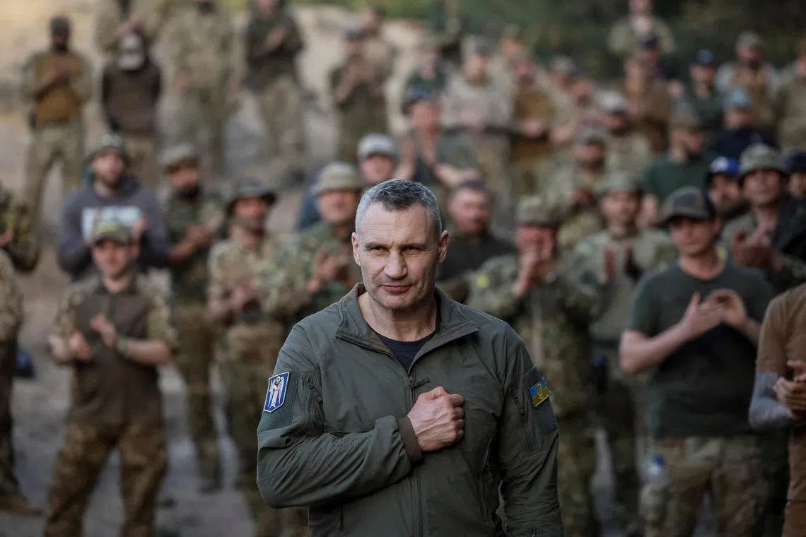 FILE PHOTO: Kyiv Mayor Vitali Klitschko greets servicemen of the Svoboda (Freedom) battalion from the elite Storm Brigade \"Rubizh\" of the National Guard of Ukraine before an award ceremony for fighters, who have recently returned from the frontline in the Bakhmut area of Donetsk region, amid Russia's attack on Ukraine, in Kyiv region, Ukraine April 11, 2024. REUTERS/Gleb Garanich/File Photo